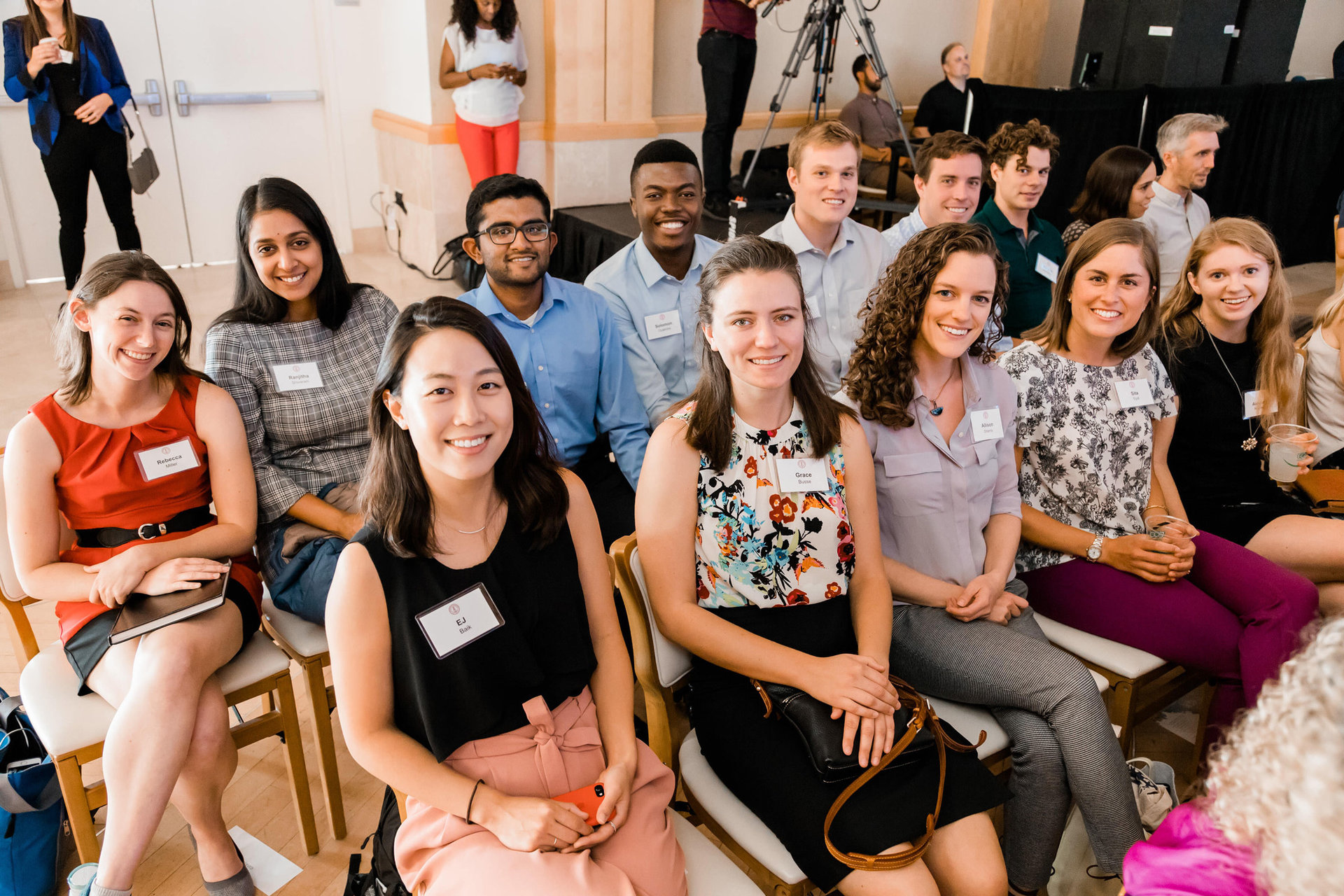 a group of students and research assistants sit together at an event