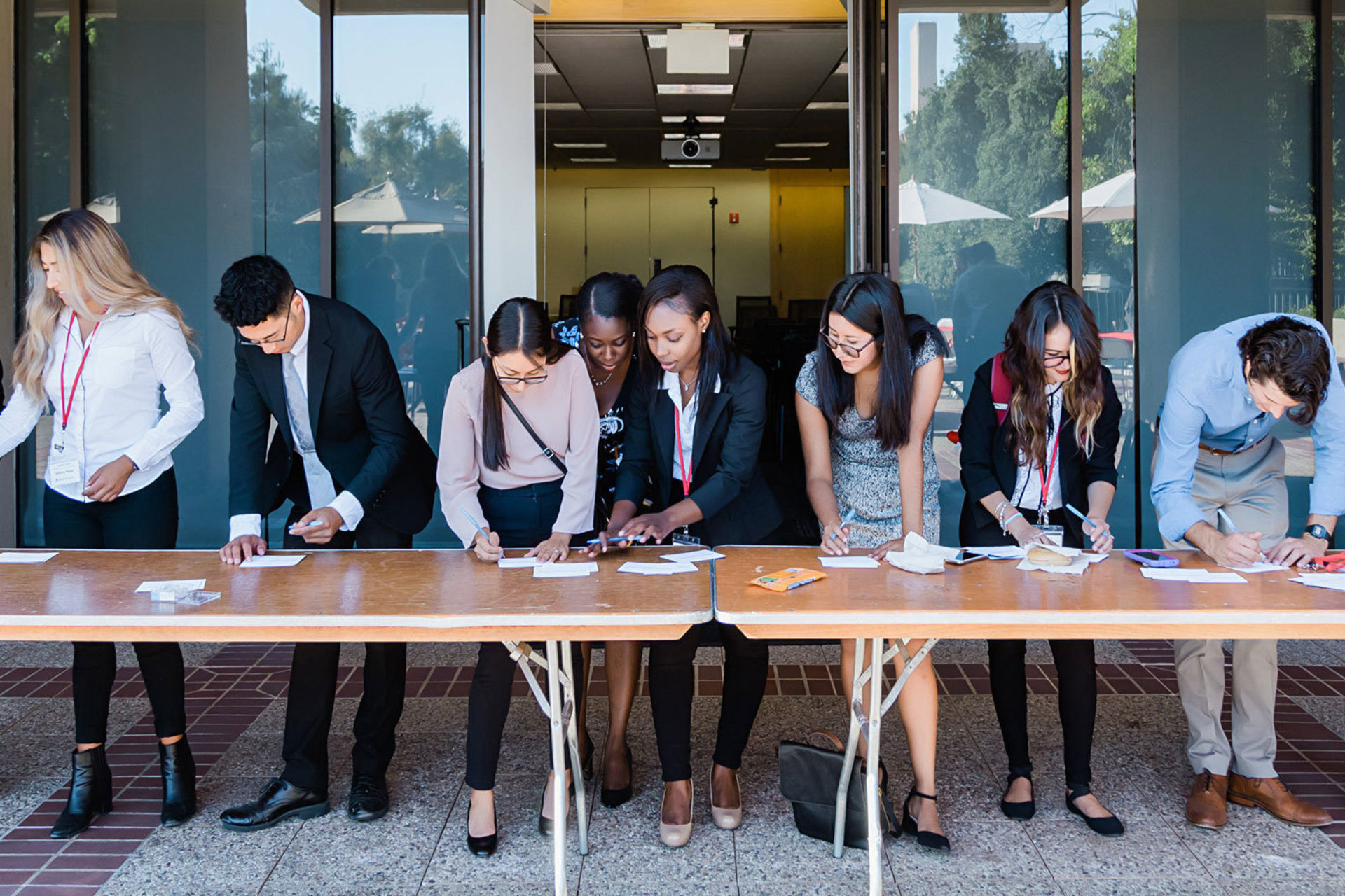 SURGE participants dressed up and writing on tables outside the Mitchell Earth Sciences building